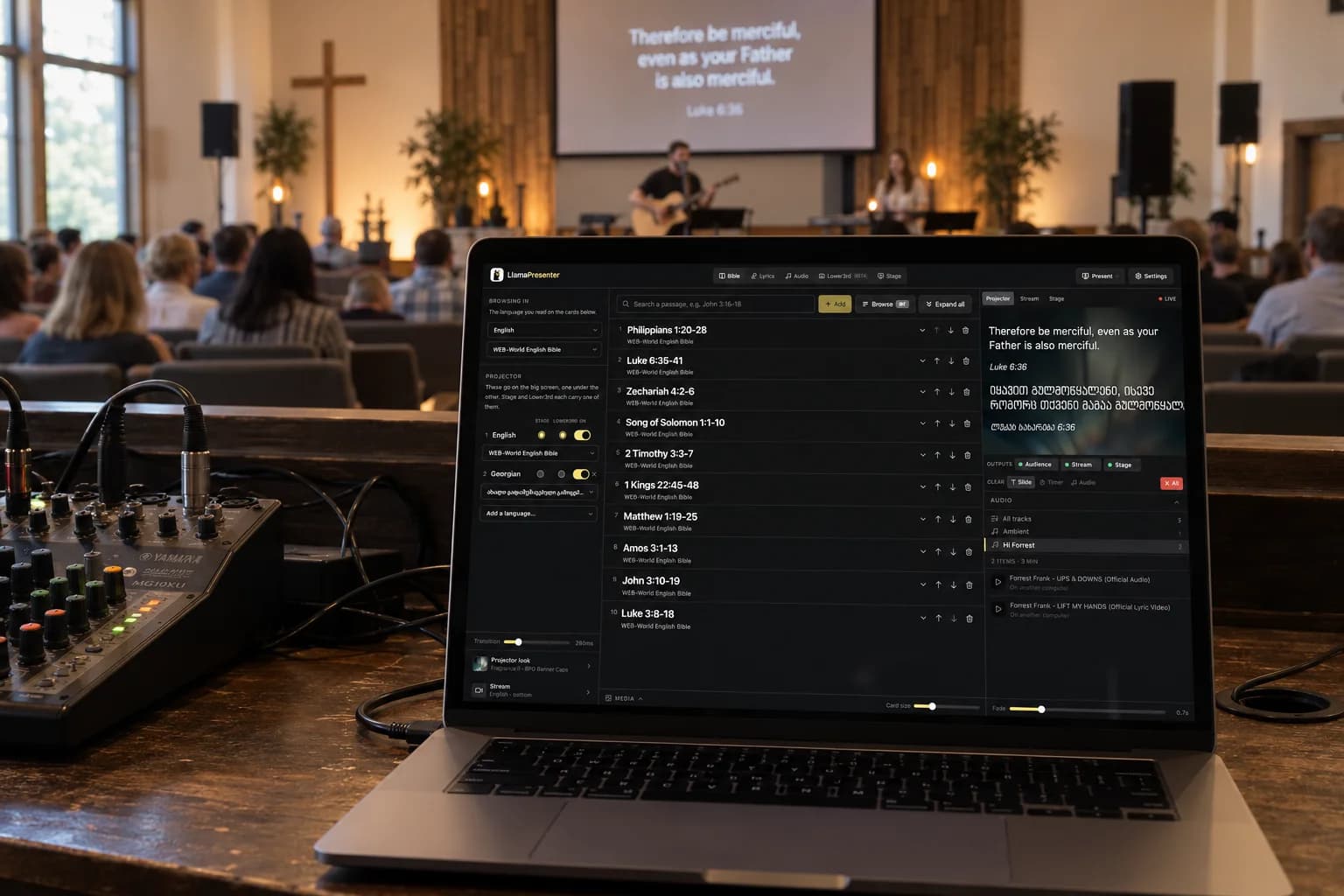 A small sanctuary during worship, the LlamaPresenter console open on a laptop beside a sound mixer and the verse on the screen at the front