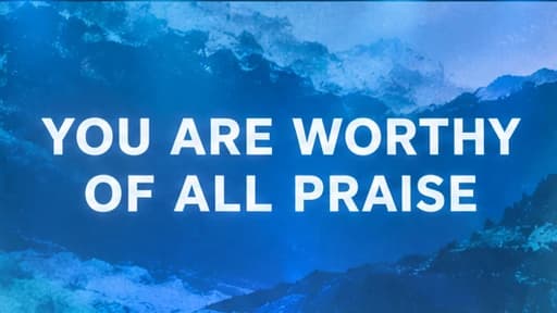 A blue mountain background displaying You are worthy of all praise in large white text